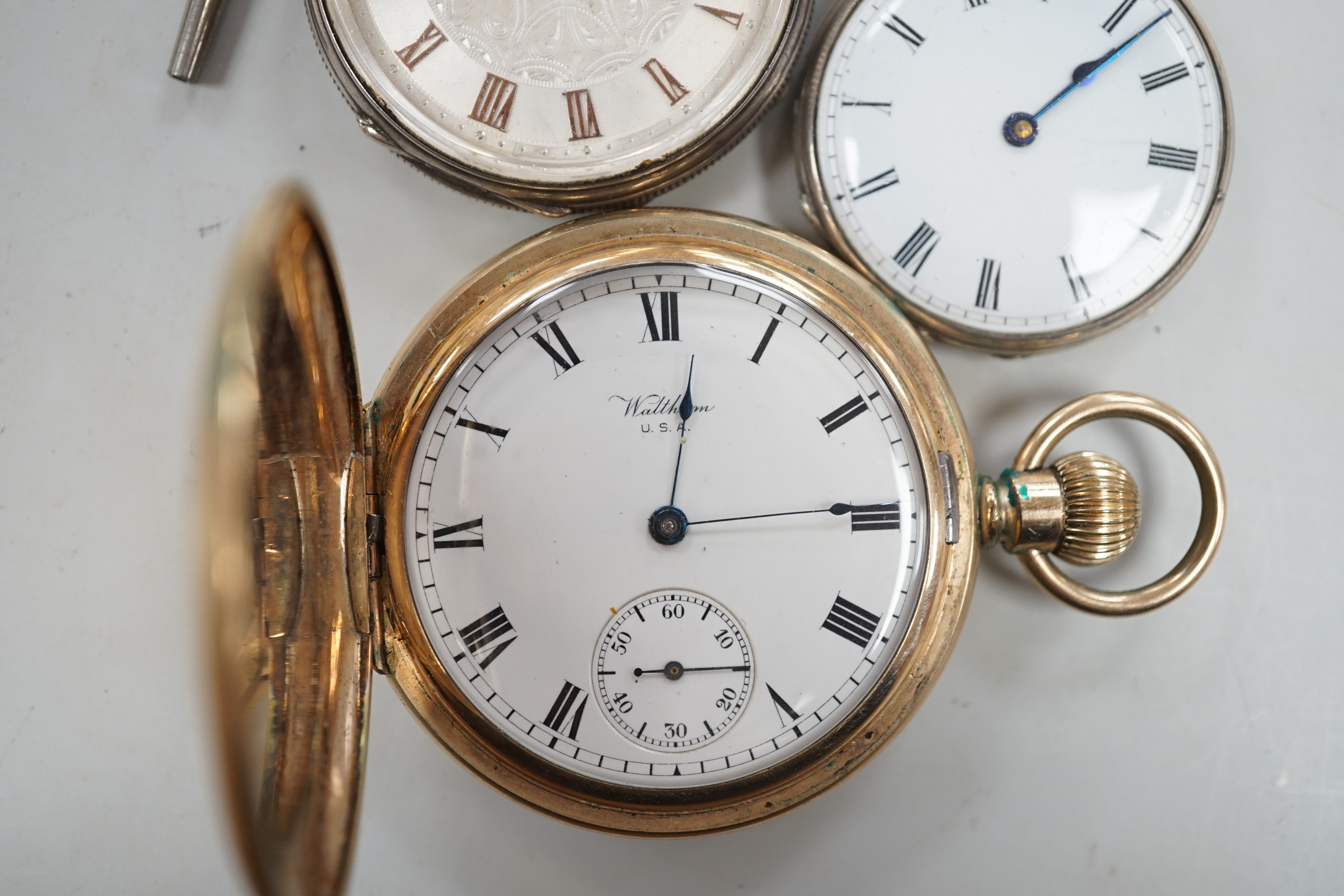 A Waltham gold plated hunter pocket watch and two fob watches, one silver.